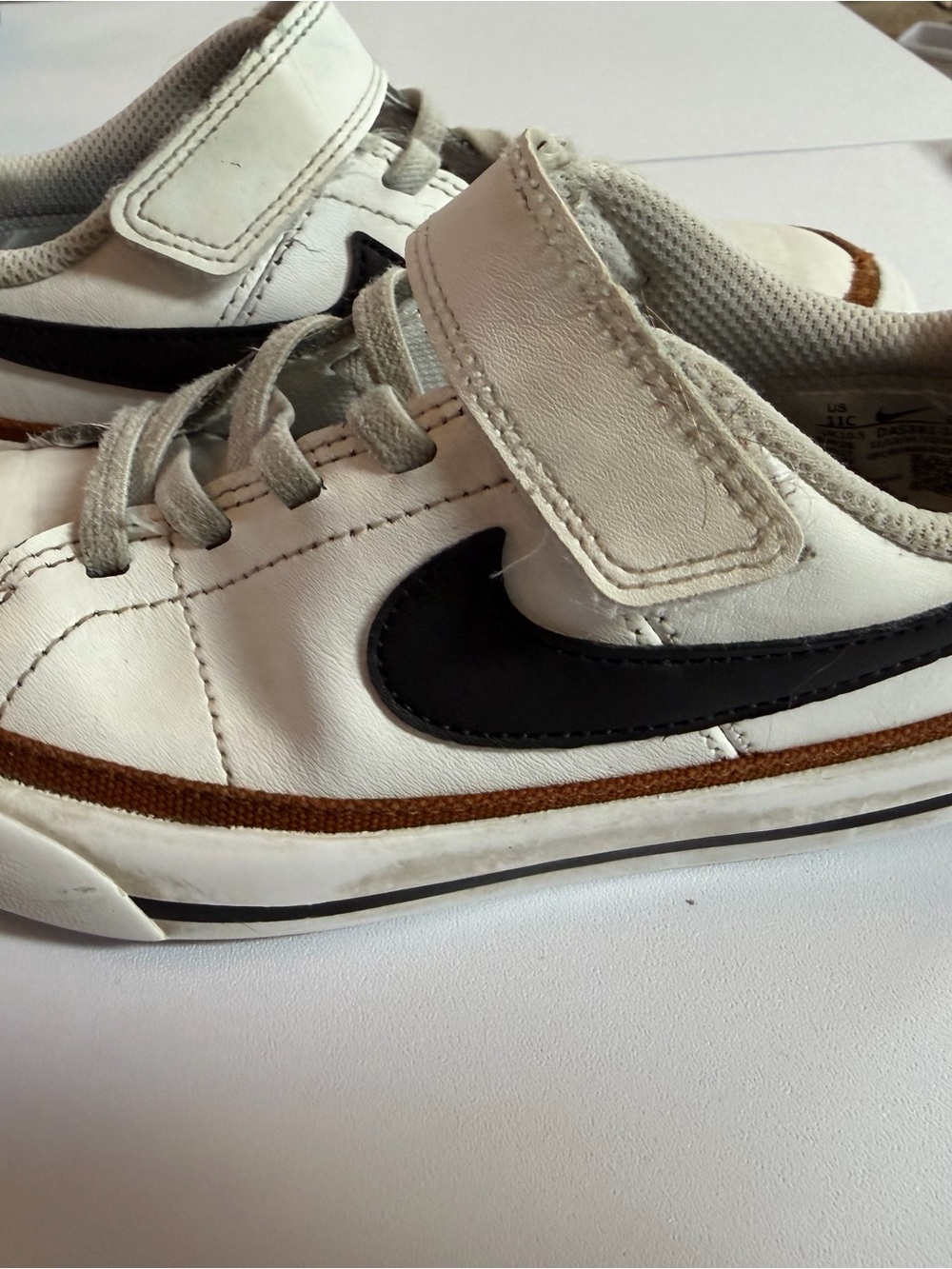 Nike Kids White Sneakers with Black Swoosh and Brown Trim - Velcro